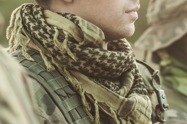 Soldier in a military clothes standing to attention and looking straight ahead