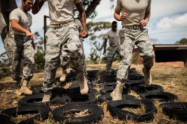 Trainer giving training to military soldiers at boot camp